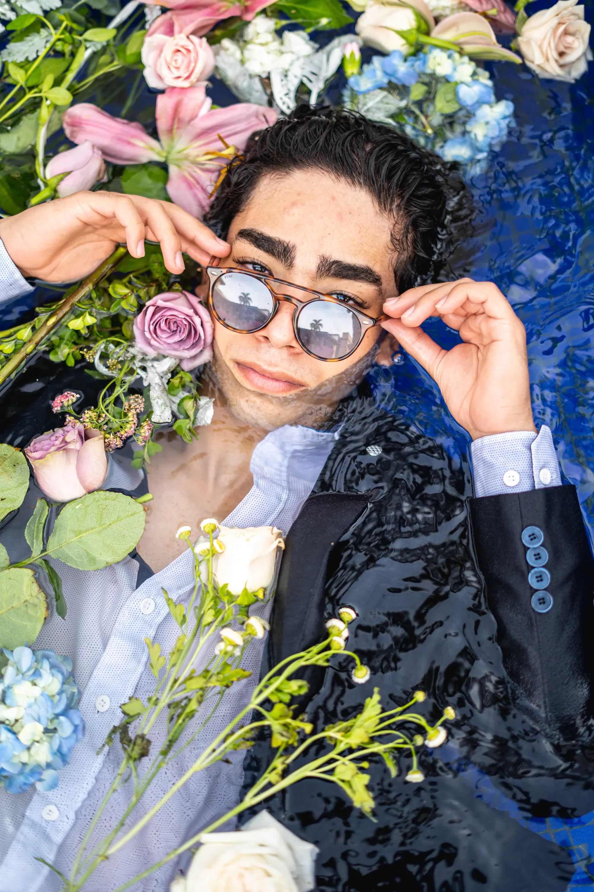 Modelo ajustándose los lentes entre flores